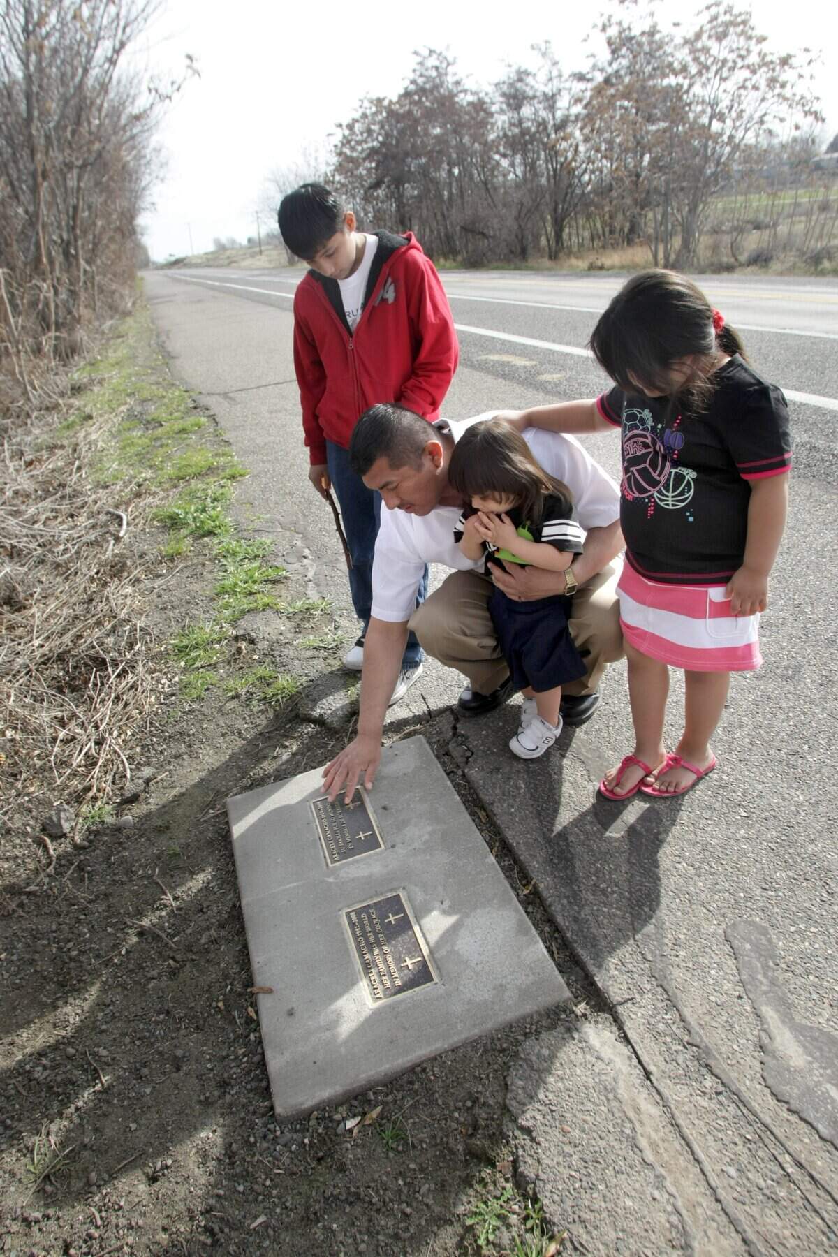 In 2010, Juan Campos Gomez and his children visit the site in Columbia Park where Araceli Camacho Gomez was found dead in June 2008. Two plaques, one in English and the other in Spanish, mark the site.