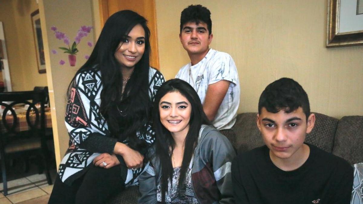 Siblings Karen Montes, left, Froilan Godines Jr., Princess Godines, center, and Aaron Godines, right, talked Tuesday about their memories of their father Froilan Godines inside their Kennewick home. “The younger ones look just like him,” said their mother, Guadalupe Orturo.