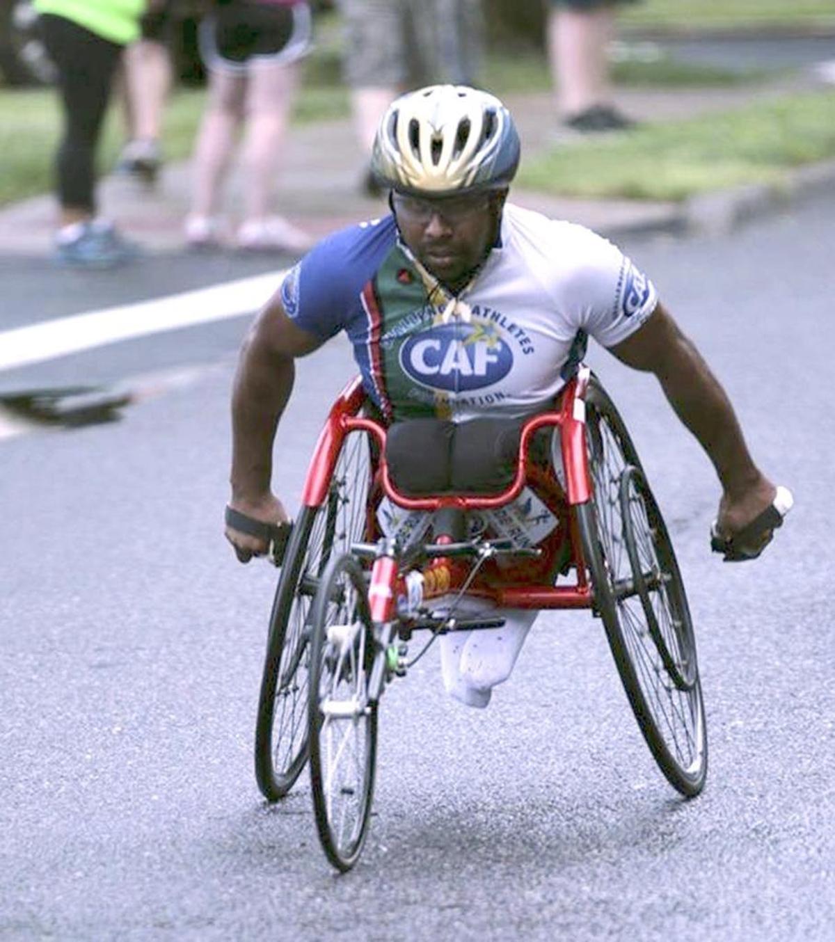 Paraplegic Hassan Yusuph competes in the Tri-Cities Marathon in a specially designed racing wheel chair.