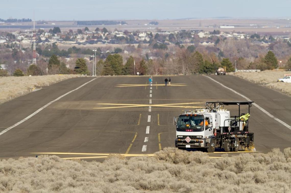 The Arts Center Task Force will unveil conceptual designs for its Vista Art Center project on Aug. 22. Vista Arts Center will anchor the Port of Kennewick’s Vista Field redevelopment. Above, a crew paints Xs on the former runway to deter pilots from landing in the heart of the city.