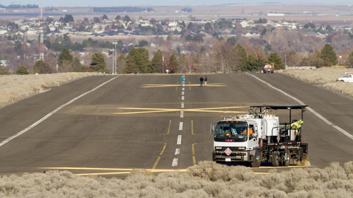 The Arts Center Task Force will unveil conceptual designs for its Vista Art Center project on Aug. 22. Vista Arts Center will anchor the Port of Kennewick’s Vista Field redevelopment. Above, a crew paints Xs on the former runway to deter pilots from landing in the heart of the city.