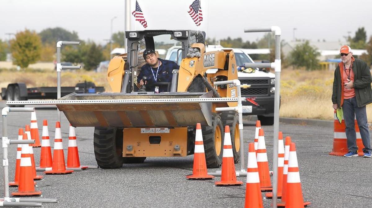 Austin Salvati, a public works employee from the city of Bothell, concentrates on seeking the path of least resistance Thursday while participating in the skid steer obstacle course at the 7th annual Equipment ROADeo & State Finals held by the Washington Chapter of the American Public Works Association. Event judge Travis Hunt from the city of Kennewick tracks his progres. About 75 participants from about two dozen municipalities from across the state competed. The skills events included operating a skid steer, loader, backhoe and snow plow. Winners advance to compete in 2018 at the national event being held in Kansas City. Watch a video at: tricityherald.com/video