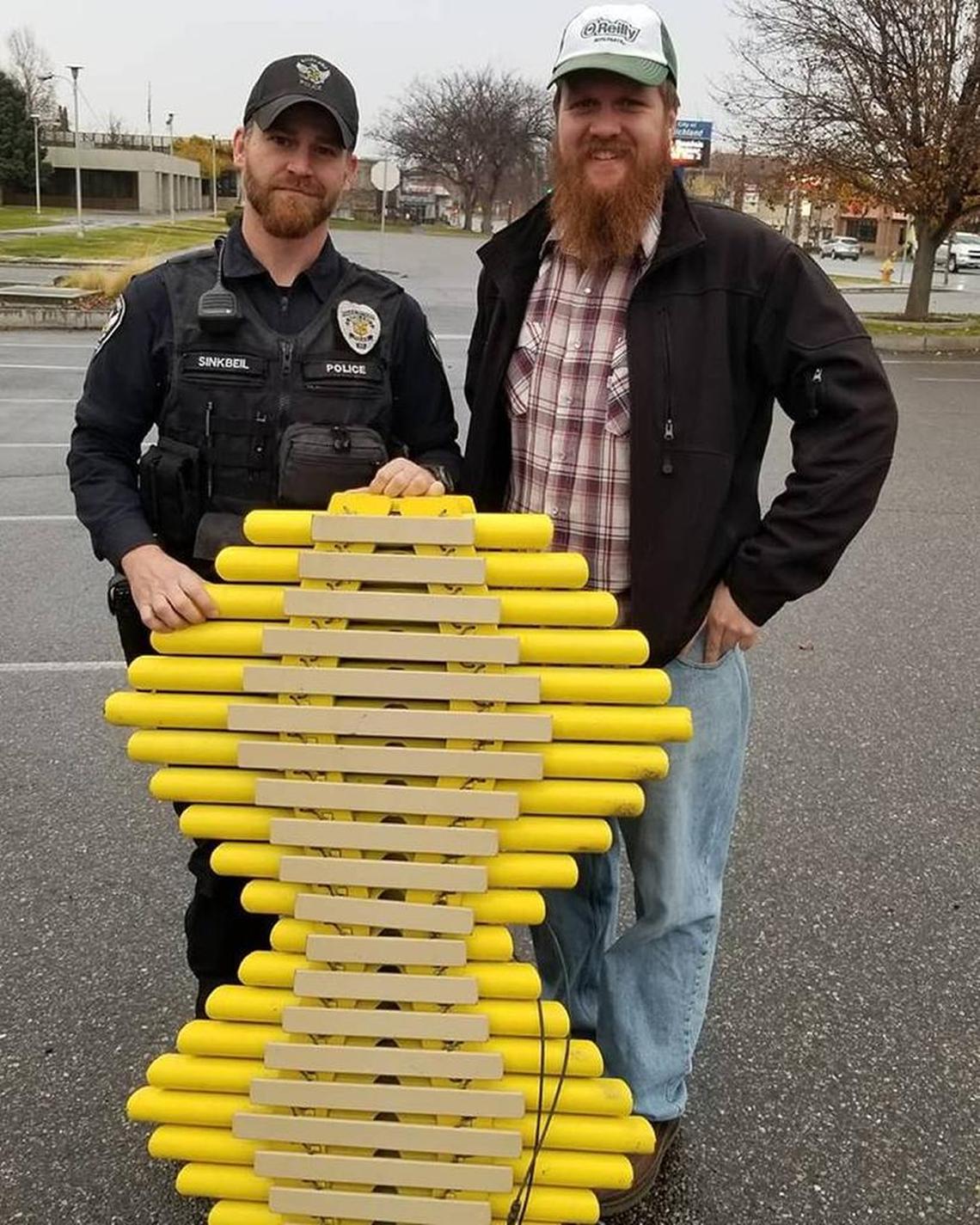 Richland police Officer Dan Sinkbeil and Jason Watson of Kennewick show the recovered marimba.