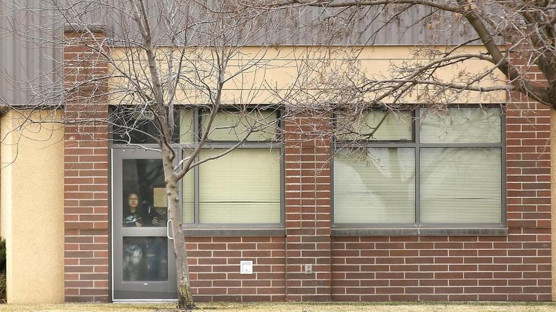 People look out a door at Kiona-Benton City High School during a lockdown after a rumor that a student brought a gun to the school. Officials said no gun was found.