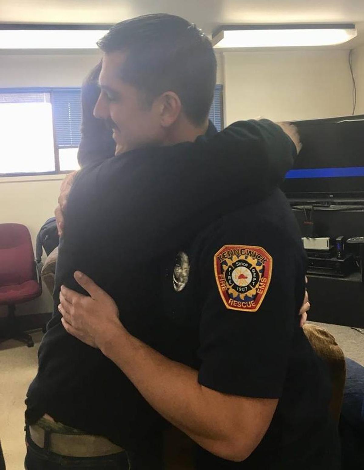 Richard Stith hugs Tony Jorgensen, the firefighter that found Dominic inside of the burning home.