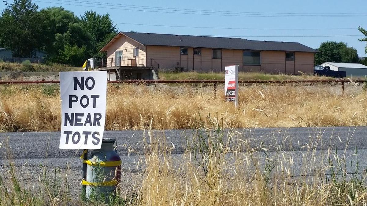 A sign objecting to The Garden LLC’s plan to move Nirvana Cannabis Co. to commercial property encircled by West Richland alerts drivers on Kennedy Road. The property meets the legal requirements for a cannabis business but neighbors say it poses a traffic and safety problem.