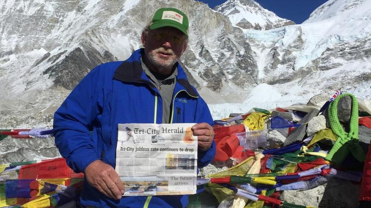 Jake Broyles of Echo, Ore., holds up a copy of an October edition of the Tri-City Herald while at Everest Base Camp in Nepal. He was in the country as part of a travel group.