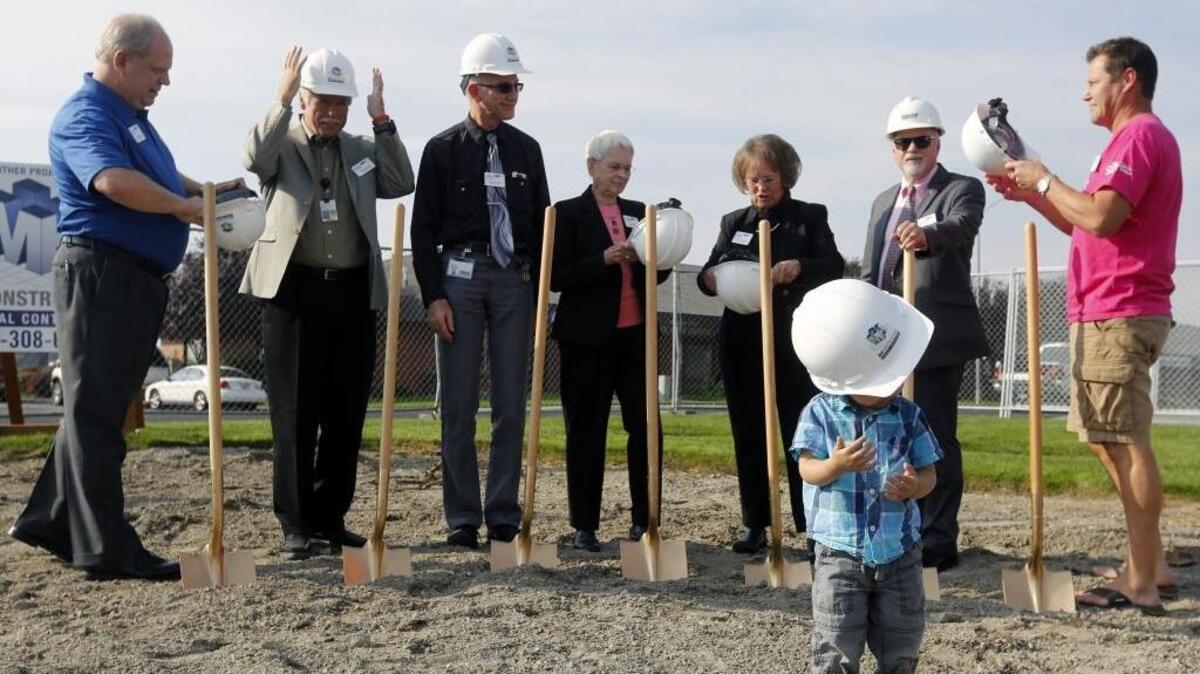 
Jet Choe, 2, son of Radiation Oncologist Dr. Juno Choe, tries on a hard hat Friday as members of the Tri-Cities Cancer Center’s board prepare to break ground for an expansion and renovation project. The project is to be done by late next summer and will house new equipment and services, including a survivorship program, palliative care program and a visiting physician clinic.
