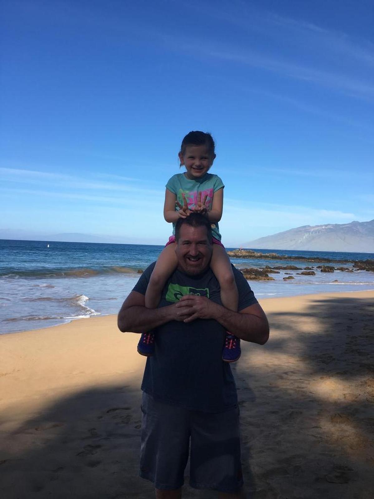 Brian Conrad and his daughter Ashelyn on a beach in Hawaii.