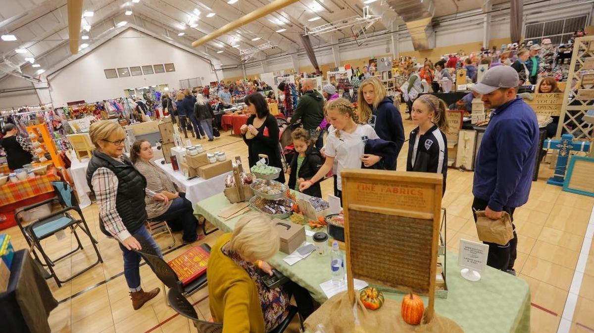 Locals gather inside Southridge Sports Complex Pavilion to shop during for the 27th-annual Harvest Bazaar on Saturday in Kennewick.