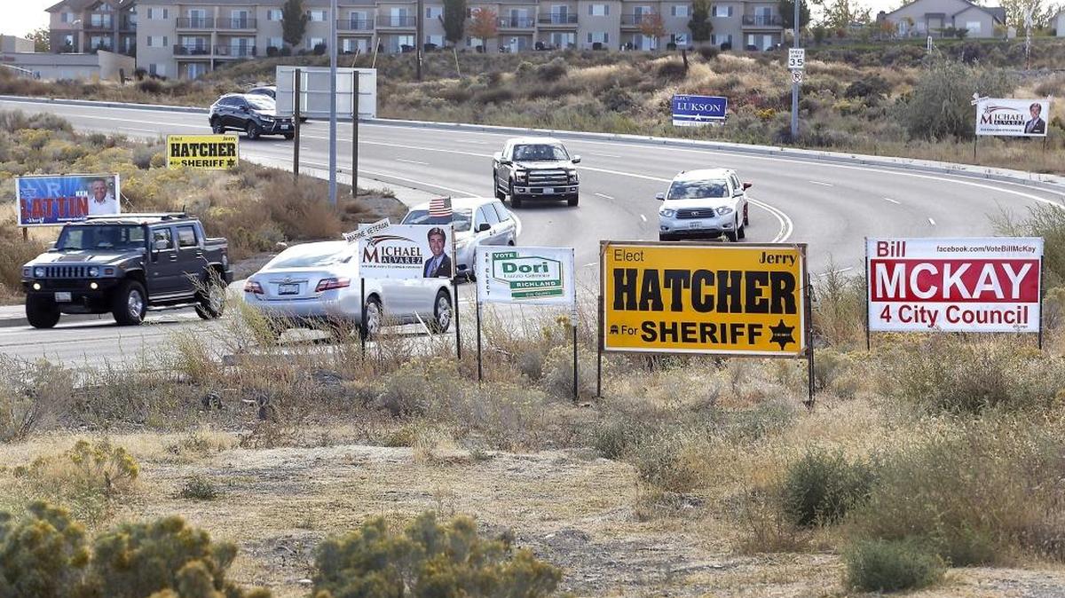 Motorists drive past a multitude of political signs near the Steptoe roundabout in Richland. The Republican and Democratic parties of both Benton and Franklin counties have either endorsed or recommended candidates in local nonpartisan races, an unusual move that injects politics into local races in a new way.
