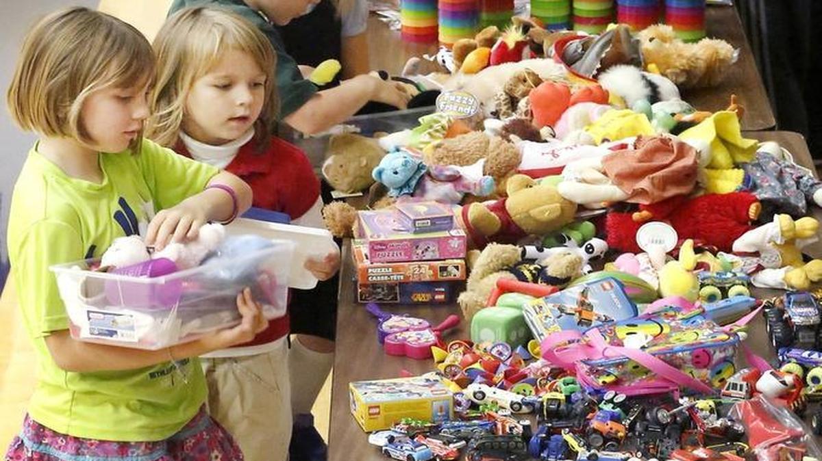 Second-graders Michaela Allwardt, left, and Eileen Fritz work together Thursday filling a box with school supplies, hygiene items, toys and candy at Bethlehem Lutheran School for the annual Operation Christmas Child project. The Samaritan’s Purse program fills boxes with donated supplies that are shipped to children in need around the world. The 250 students at the private Kennewick school expected to fill about 135 boxes, according to collection center coordinator Amy Thornton.
