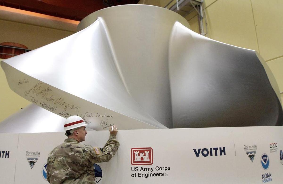 Lt. Col. Timothy Vail, commander of the Walla Walla District of the Army Corps of Engineers, adds his name to a list of signatures of key participants on a new high-tech turbine at Ice Harbor Dam on the Snake River near Burbank. It was designed to be fish friendly and increase power efficiency.