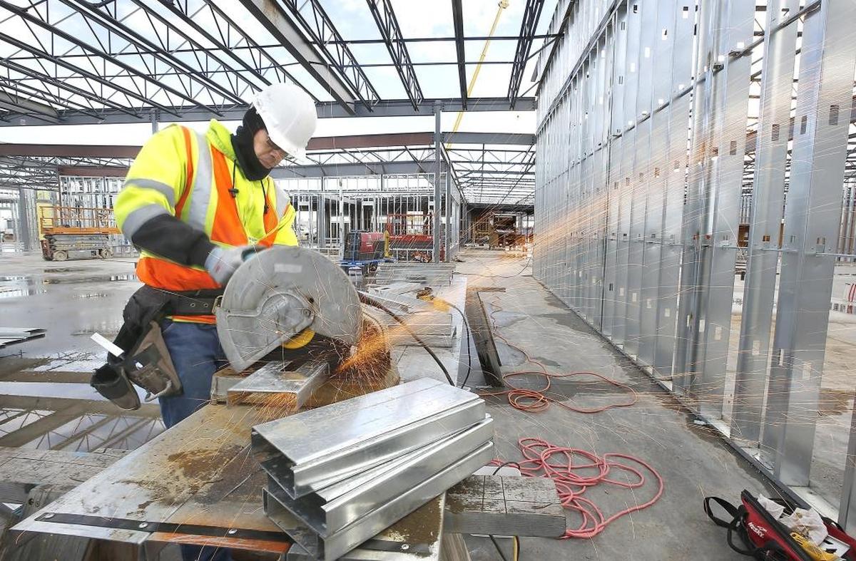 Construction worker Terry Powell, an employee of Horizon Construction Services in Pasco, cuts pieces of steel stud framing Friday morning while working on the new Tri-City Union Gospel Mission men's facility in Pasco. The new $10.4 million 40,000-square-foot building being constructed at South Third Avenue near West Columbia Street is expected to open in October.
