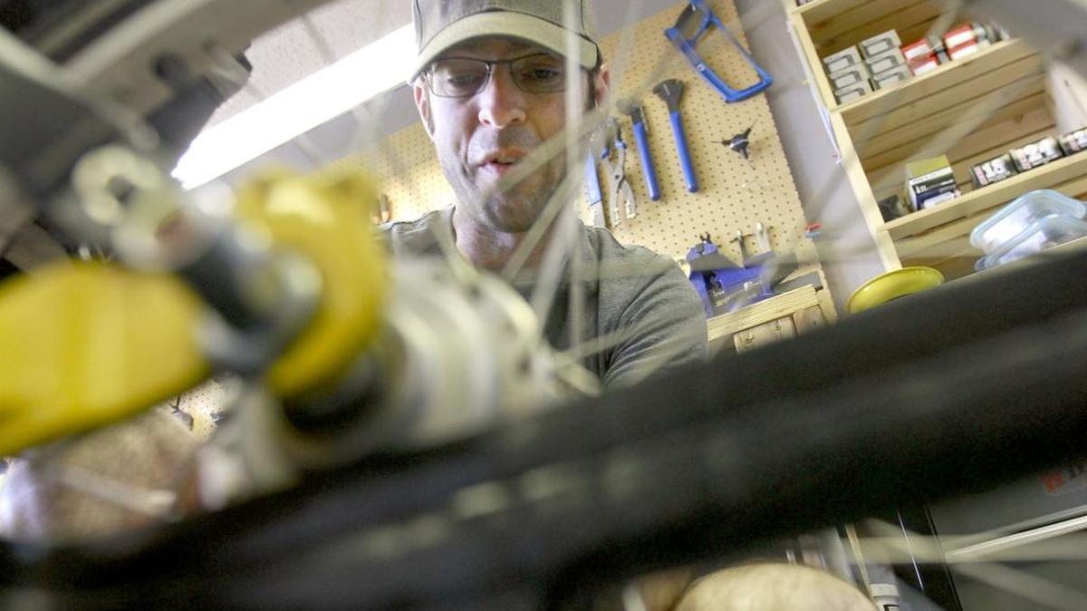 David Spaulding, executive director of Wheelhouse Community Bike Shop, works on a Terratrike at the downtown Kennewick shop.