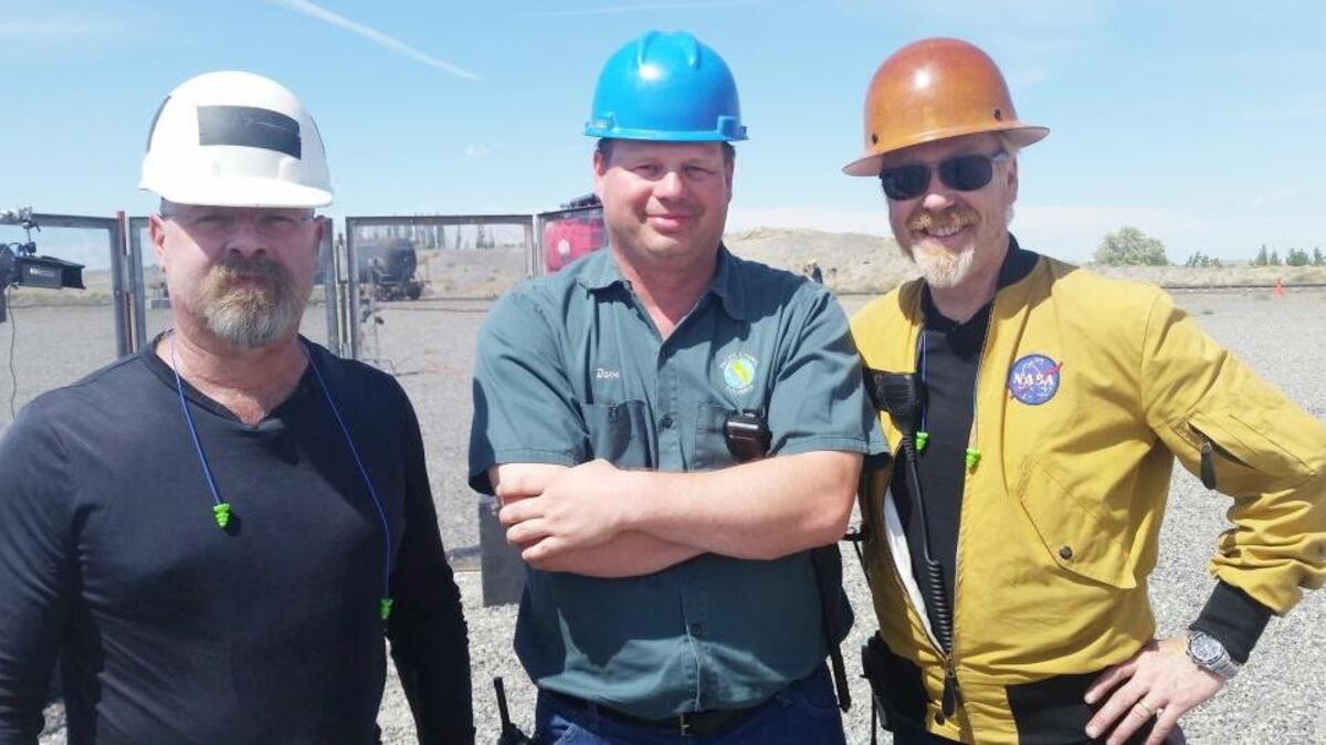 ‘MythBusters’ hosts Jamie Hyneman, left, and Adam Savage, right, pose with Pacific Ethanol employee David Richards during filming in July 2015 at the Port of Morrow.