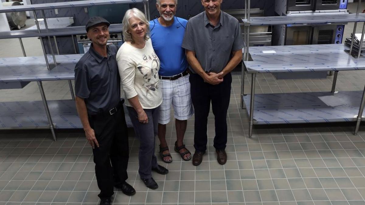 Members of the Mid-Columbia Meals on Wheels family, from left — Brian Kinner, food service manager, Marcee Woffinden, nutrition services director, Nick Castorina, volunteer and construction manager, and Grant Baynes, executive director — stand in the organization’s new kitchen in Richland.