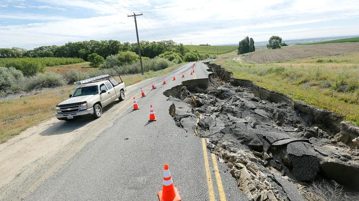 A pickup recently skirts around the heavily washed-out section of roadway on Ironwood Road between Garfield and Langford Roads in Franklin County.