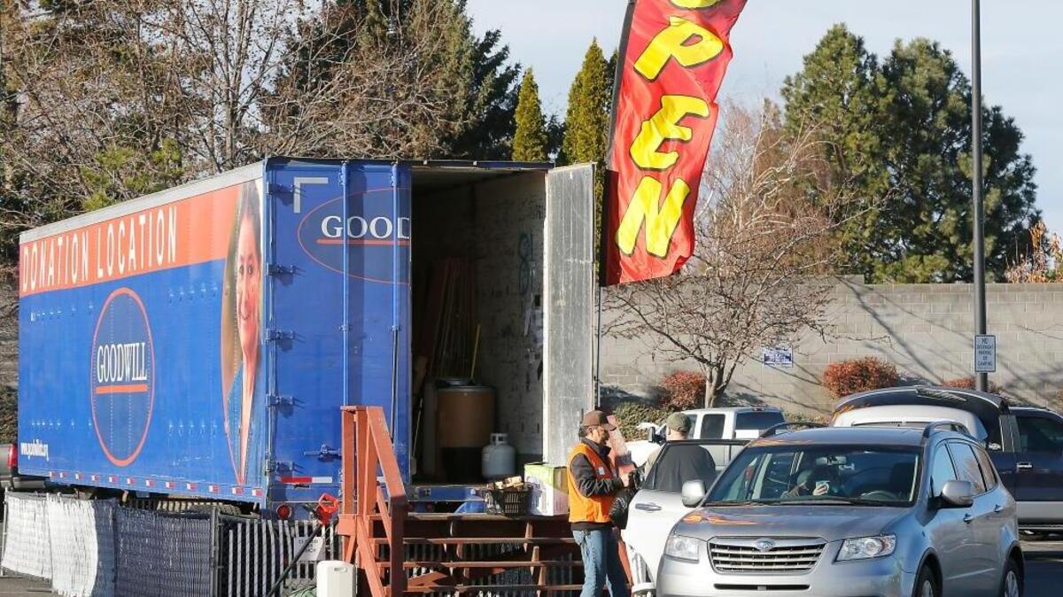 Just a little over a year after the 24 local drivers for Goodwill Industries voted to join the Teamsters, the union faces a decertification vote. Jesus Ramos, left, an employee for the donation site in the Kennewick Fred Meyer parking lot, helps unload donations Monday into one of the trailers.