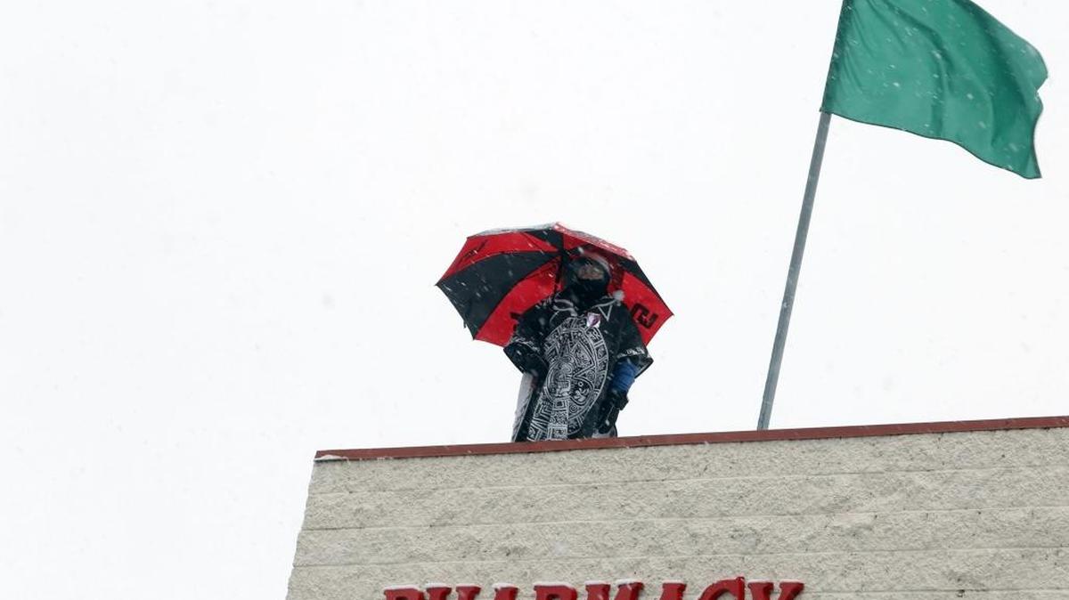 Radio DJ Gaudencio Sanchez, “The General,” walks on the roof of Fiesta Foods as part of station La Ley 99.5’s annual food and clothing drive for charities. He has been up there since Monday and plans to come down at 5 p.m. Friday after 99.5 hours. Other station members are in the parking lot collecting donations until Friday evening, said station host Norma Quintana.