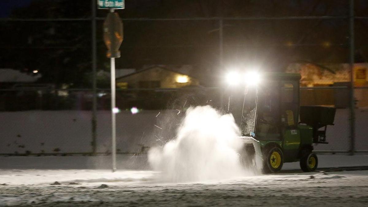 Sidewalks around Kennewick High School get an early brush-off Friday morning by a tractor following a night of snowfall around the Mid-Columbia. Many schools around the region are on a two hour delay because of the winter weather conditions. More light snow is expected throughout the day and another 1-2 inches is predicted for evening. Check bit.ly/snowdelays for school delays or closures.