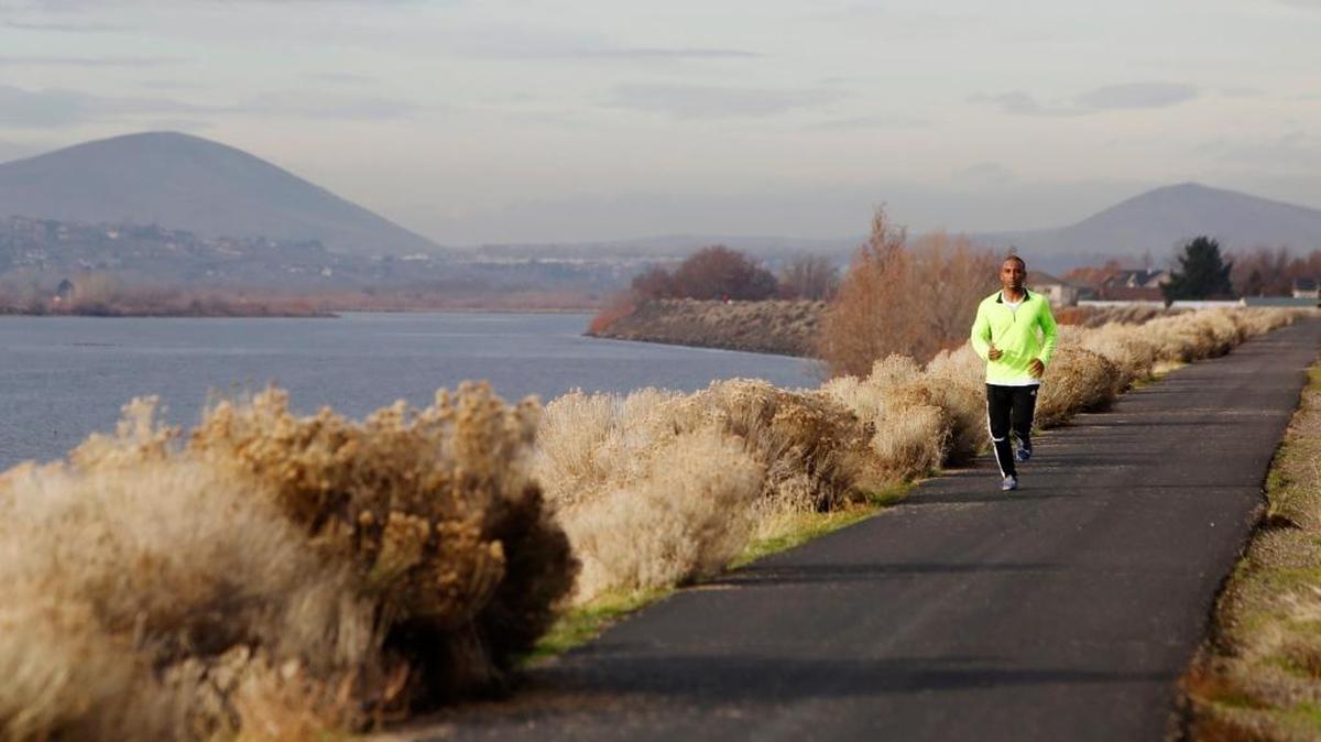 Justin of Mungal, of South Dakota, runs on the levee part of the biking trail between roads 54 and 72 in Pasco in 2014.