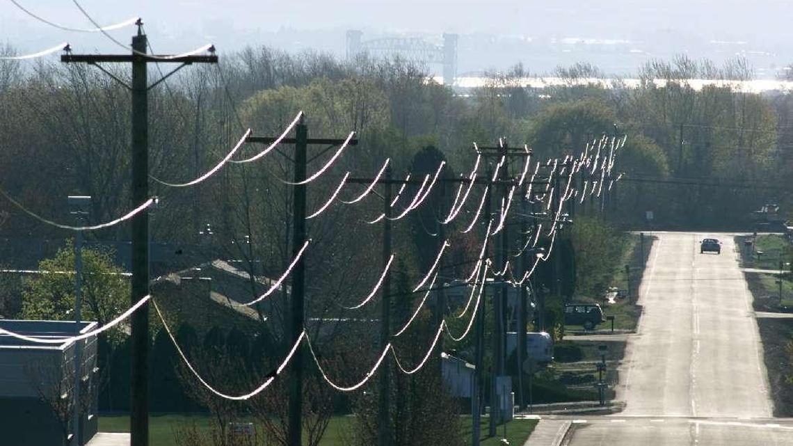 Early morning sunlight illuminates power lines stretching along West 36th Avenue in Kennewick.
