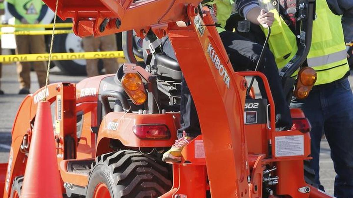 
Southridge High student Cooper Christensen, 15, is coached Tuesday by volunteer Reuben Harvey, a Walla Walla Community College student, while operating a backhoe at the 10th annual Tri-Cities Construction Career Day at the Benton County Fairgrounds in Kennewick. More than 500 students from the Mid-Columbia had a chance to explore careers in construction and construction related industries with hands-on experiences in masonry, electrical, welding, sheet metal and heavy equipment.

