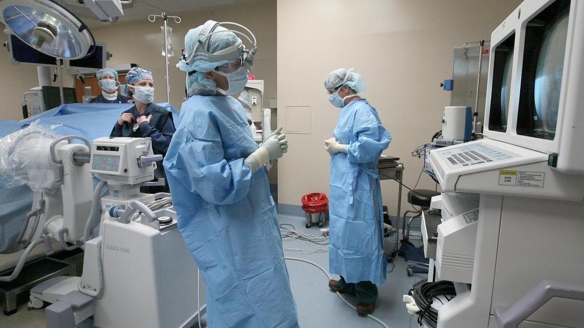 Nurses and doctors work in an operating room during a surgical procedure at Kadlec Regional Medical Center in Richland. It was announced Wednesday night that the Kadlec Regional Medical Center management and nurses have reached a tentative contract agreement.