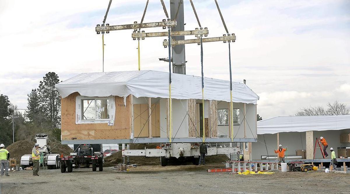 Construction workers help guide the second module of a new classroom building into place by crane at Hanford High School in Richland. Hanford Site Payments in Lieu of Taxes have helped pay for portable classrooms for the school district.