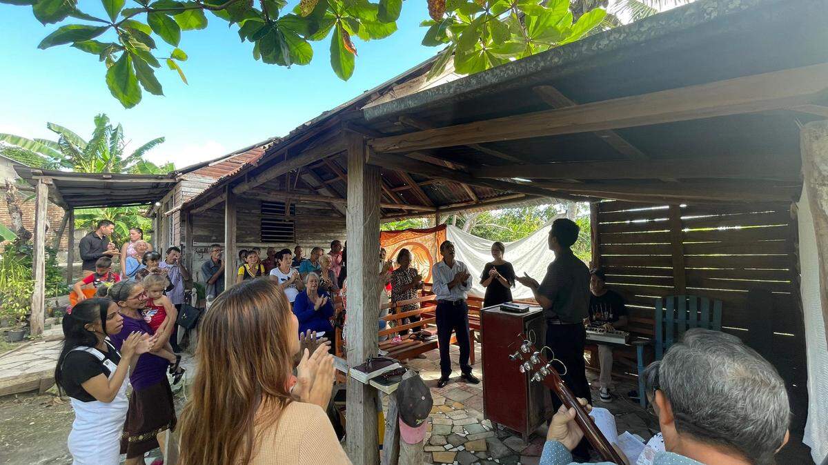 Cubans worship together in a house church where the pastor lives in a small portion with family in the back.