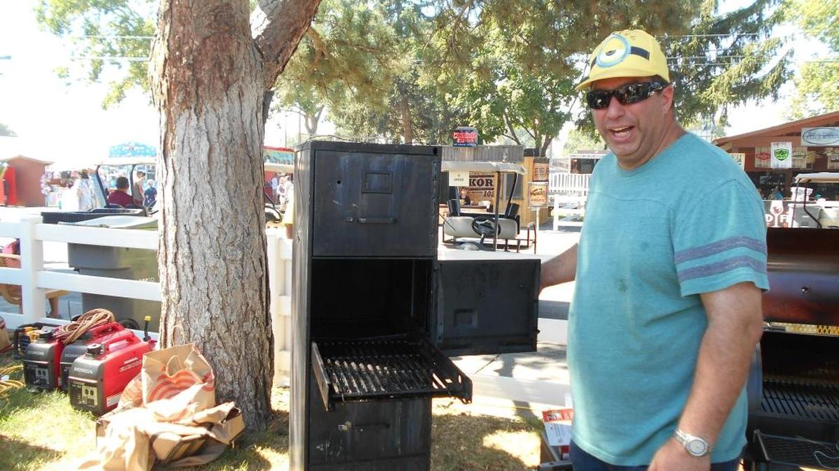 Don Salyer of Richland Lutheran Church’s competition barbecue crew, Lutefisk on the Loose!, shows off a smoker fashioned from a four-drawer filing cabinet. It’s light and cheap, he said during a break in competition at the Benton-Franklin Fair Saturday. The filing cabinet lacks insulation, but it was free, Salyer explained.