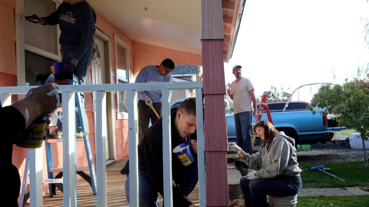 Tri-Tech student Colton Pomrankey, center, helps volunteers from Areva paint a home Saturday on Shoshone Street in Pasco. The painting was part of Rebuilding Mid-Columbia’s community revitalization project, in which 60 volunteers worked on homes in the neighborhood. See a video at tricityherald.com/video