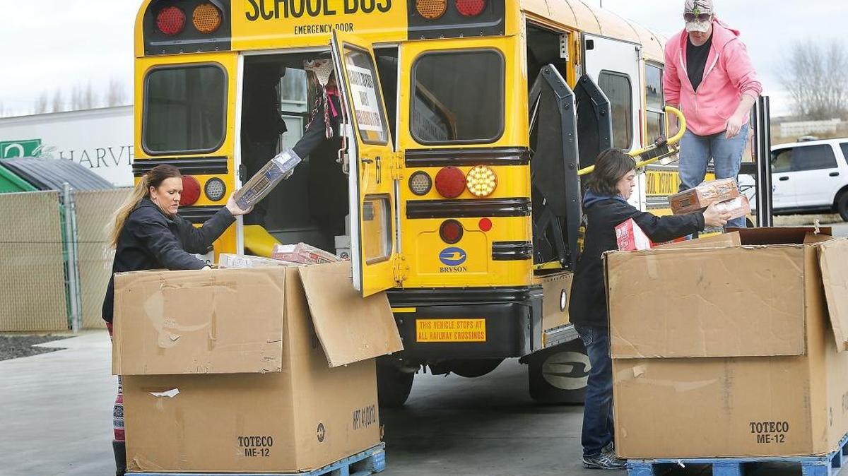 Pasco School District transportation employees unload one of four buses filled with nonperishable food Monday. The 8,281 pounds of food is more than double last year’s district-wide collection and is part of the fifth annual Fill-the-Bus drive. It will provide about 6,900 meals to be distributed to those in need through 25 partner food banks and meal programs in Benton and Franklin counties, said Jean Tucker of 2nd Harvest. Watch a video at: tricityherald.com/video.