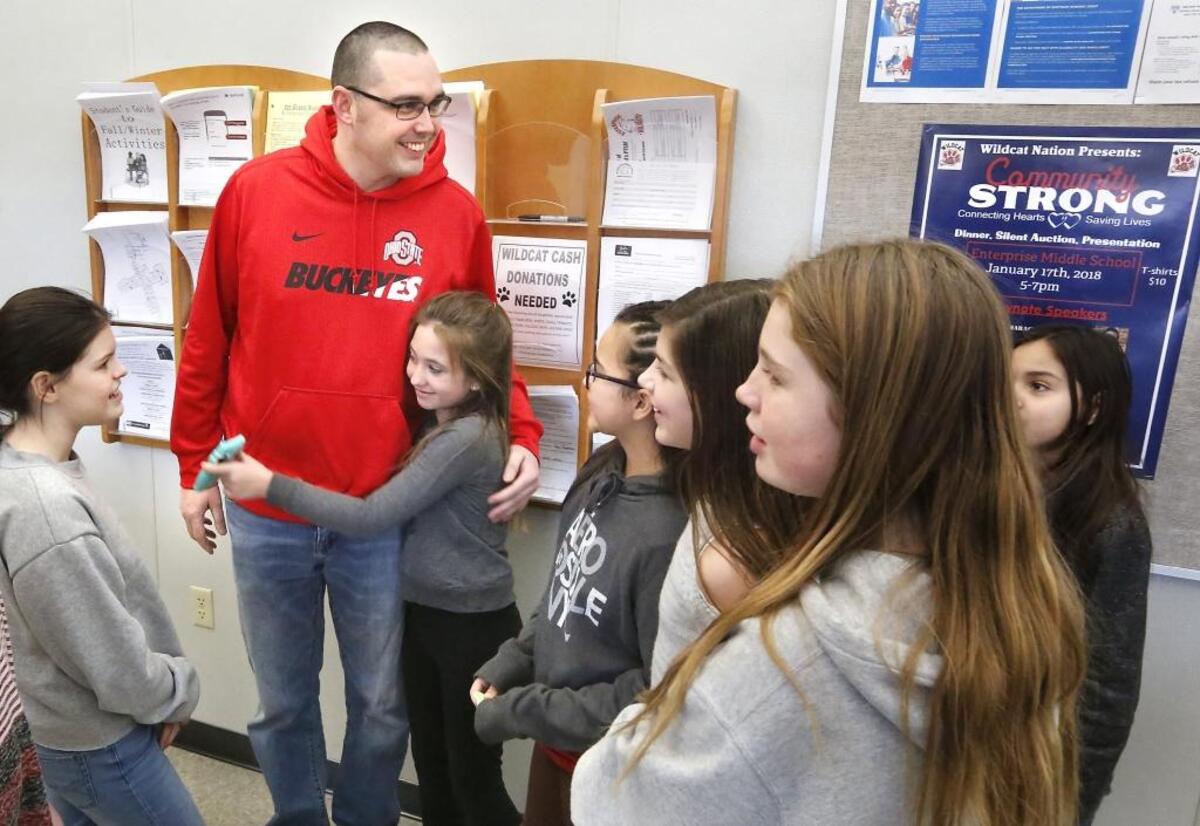 Teacher Ben Brost is swarmed by Enterprise Middle School students during a recent visit to the West Richland school. Brost hasn't been in the classroom since suffering a cardiac arrest in November. He is now making a full recovery thanks to two CPR trained colleagues, EMTs, doctor and nurses. His medical incident is an important component to the school’s upcoming fundraiser to benefit the American Red Cross. The dinner and silent auction, being held Jan. 17, will call attention to the importance of receiving CPR training. Watch a video at: tricityherald.com/video