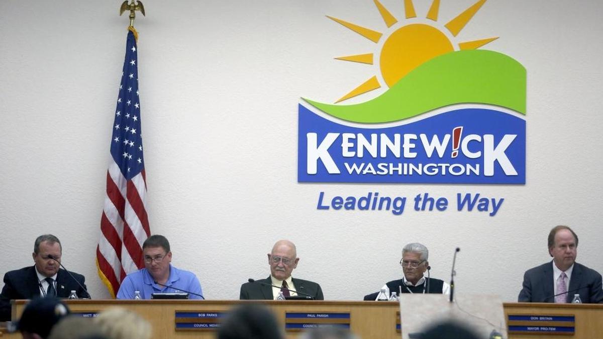 A Pasco man filed a complaint with the city of Kennewick and the Benton County prosecutor on Monday that claims Kennewick Mayor Steve Young, second from the right, violated Washington’s code of ethics for municipal officers and was conducting city business while working at the Hanford site for contractor Mission Support Alliance.