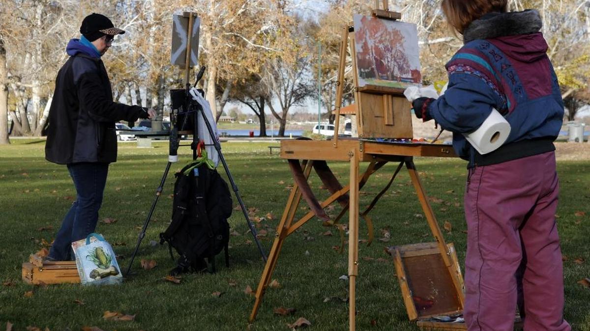 Friends Laura Gable, left, and Deanne Lemley, both of Kennewick, use oil paints to capture some of the late fall colors Tuesday at Columbia Park in Kennewick. The friends, who are professional artists, try to get together as often as possible to paint outside no matter the weather. “The colors, the lighting, everything just seems more real when you paint outside,” Gable said.