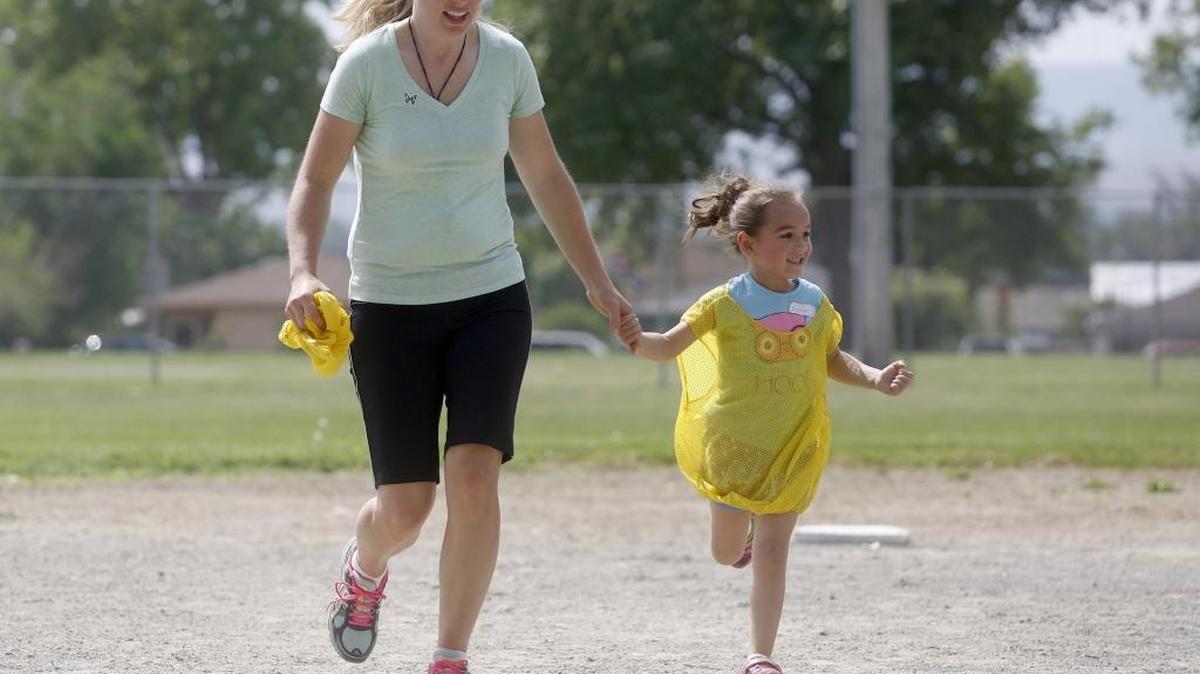 Jocelyn Chavez, right, 4, of Pasco, holds hands with instructor Megan Nelson on Wednesday during a session of Little Wigglers T-Ball at Memorial Park in Pasco. Registration is open for summer programs with Pasco Parks and Recreation at www.pascoparksandrec.com.