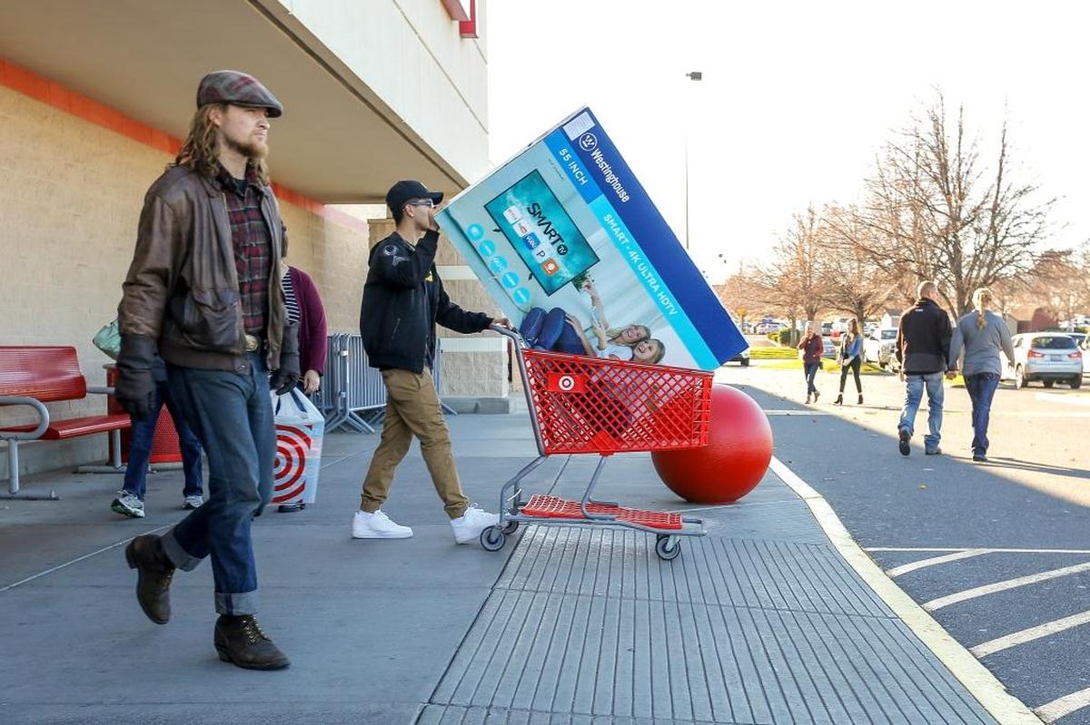 Shoppers leave Target in Kennewick with some Black Friday deals.