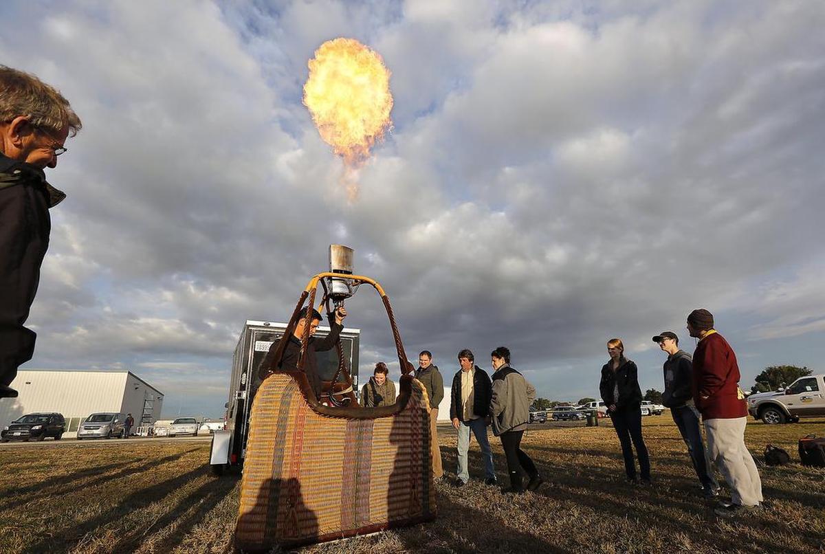 In this 2017 file photo Pilot Eliav Cohen ignites a propane fireball above the basket of his hot air balloon.