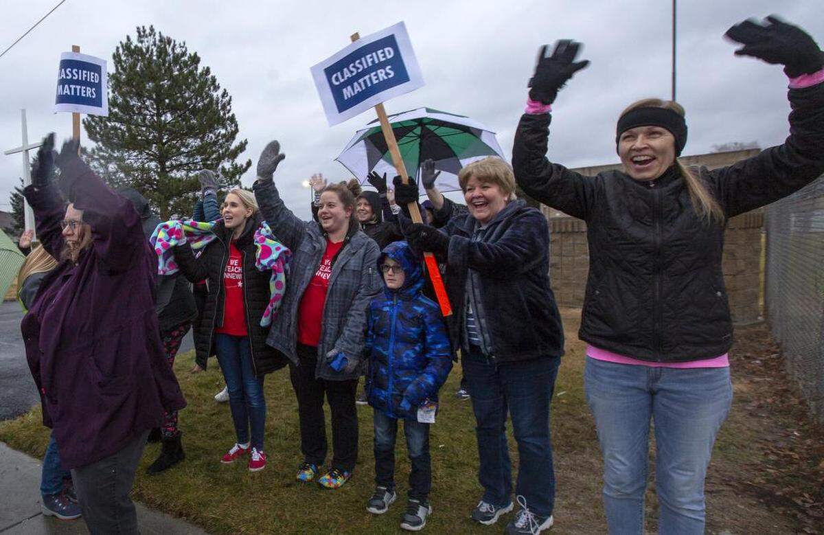 Kennewick paraeducators and supporters rally Tuesday near the school district office.