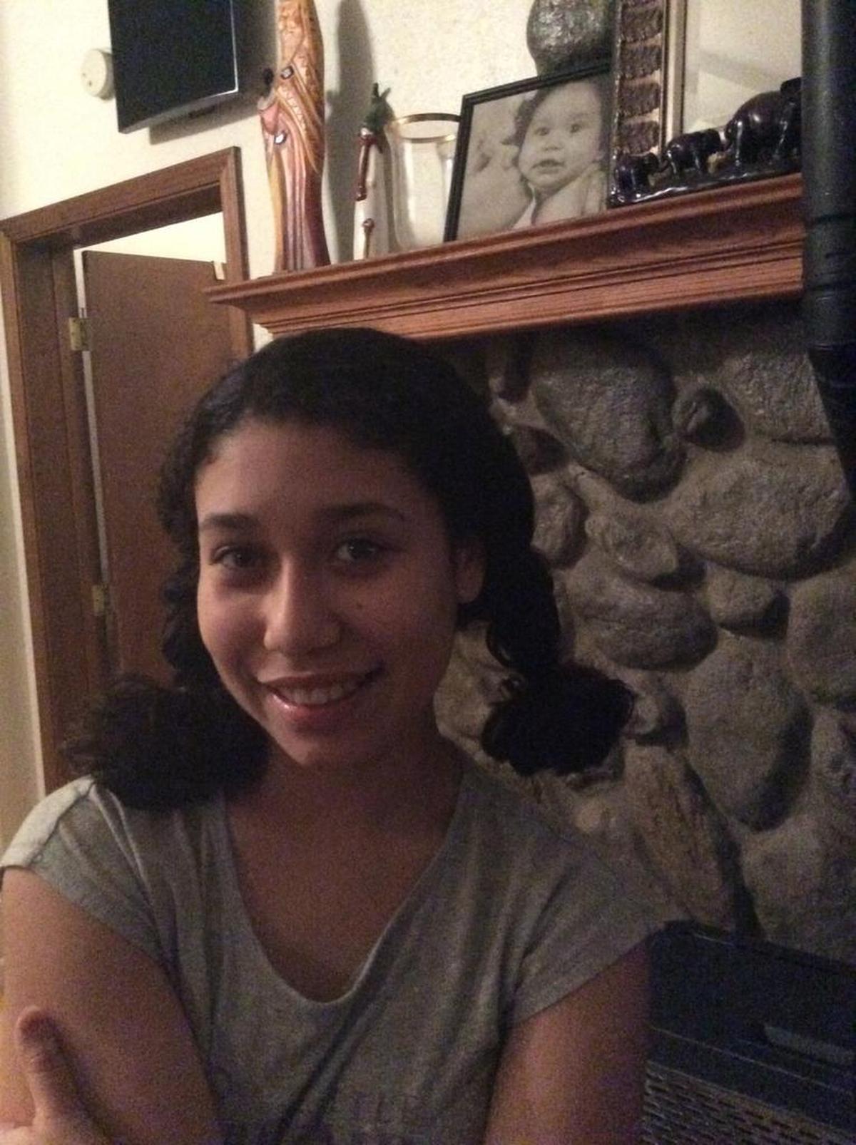 Asia had long hair before she started cancer treatment. She cut off several inches to prepare for chemotherapy.