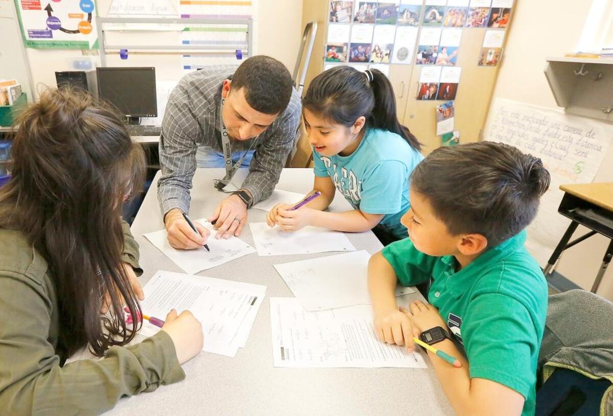 Tri-Cities school districts are working on plans for what teaching will be like this fall because of the coronavirus pandemic. Classes will be look different than in this file photo showing bilingual teacher Severo Rodriguez helping fifth-graders at Pasco’s Maya Angelou Elementary.