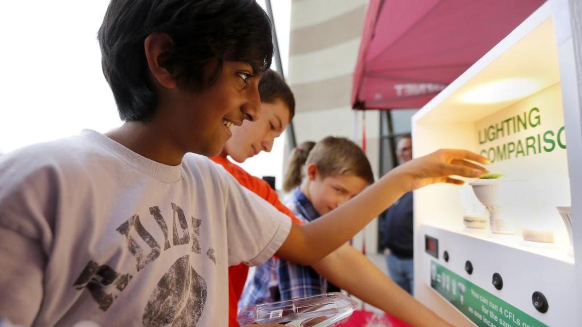 
Gurtej Nijjer, 7th-grader at Enterprise Middle School, tests the brightness of lights using a solar cricket Tuesday at the Benton Rural Electric Association booth during the Energy Experience at the Reach center in Richland. About 600 middle school students attended the summit to learn about energy generation, safety, efficiency and public power throughout interactive exhibits. See a video at www.tricityherald.com.
