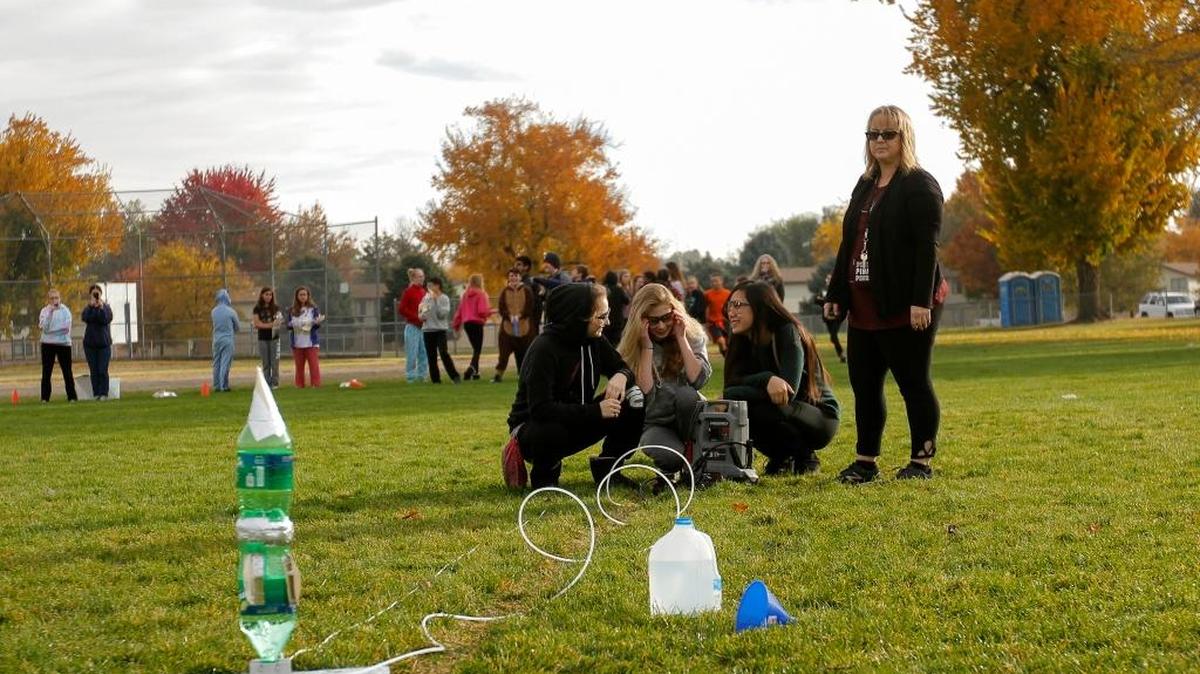 Advance physical science students at Chief Joseph Middle School in Richland watch as their classmates Isabela Riedinger, Paige McDowell, Jana Chiang and their teacher Becky Mittleider prepare to launch a rocket made of plastic bottles on Wednesday. The rockets could soar up to 150 feet.