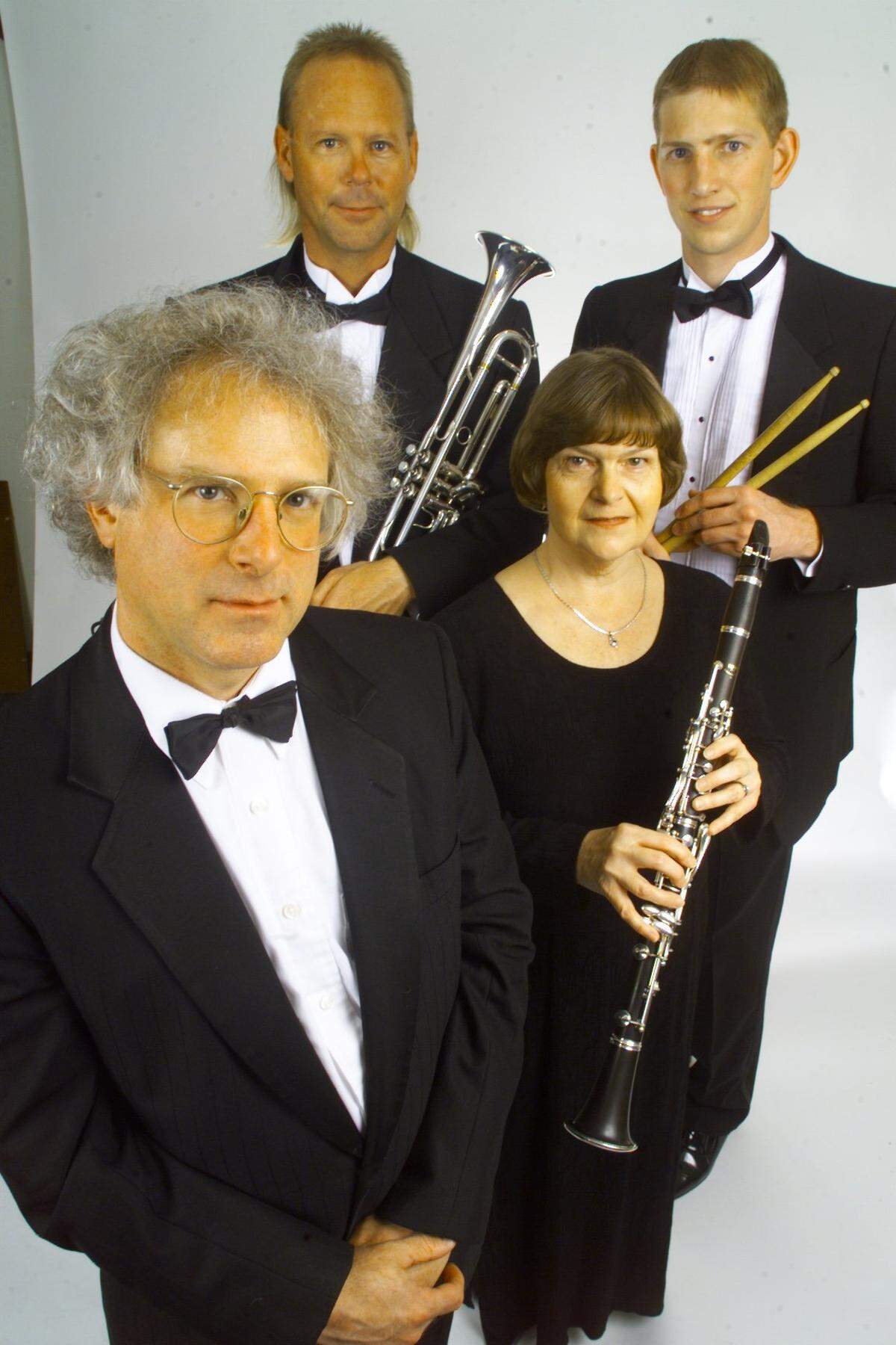 APRIL 2000 HERALD FILE: Randy Hubbs, back left, poses with Mid-Columbia Symphony composer David Glenn, front left, and others, during a photo shoot for the “Day at Carnaval” performance.