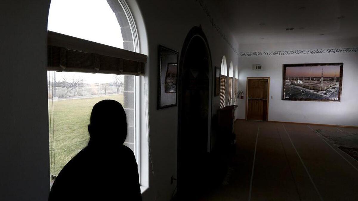 Syrian refugee Mohsin, who asked not to be identifiable in this photograph because he is worried about the safety of family members still living in Syria, arrived in the Tri-Cities this past August. He is silhouetted against a window in the prayer area of the Islamic Center of the Tri-Cities in West Richland.