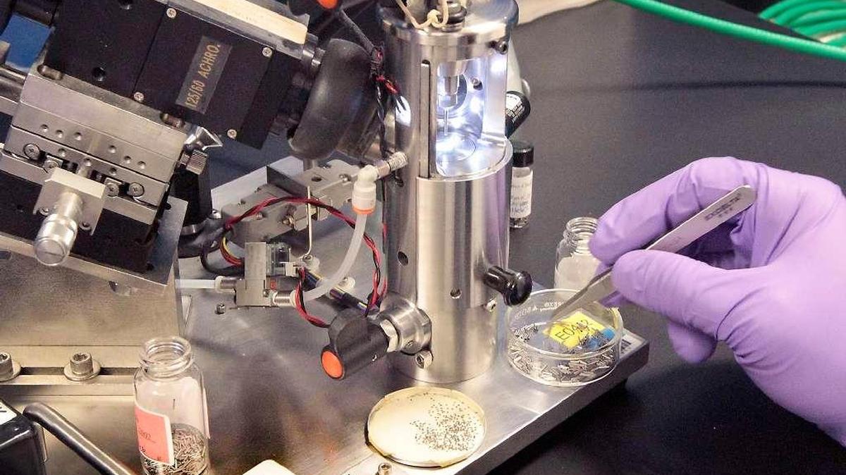 A pair of tweezers is used at IsoRay in Richland to pick up the titanium components used to make cesium-131 brachytherapy seeds for cancer treatment with radiation.