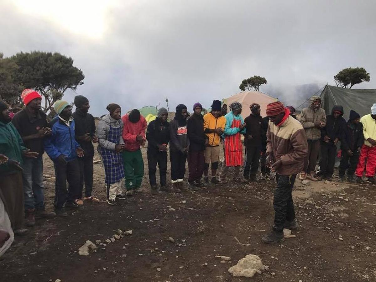 Singing is a tradition among Kilimanjaro guides and porters. In this photos, porters are singing at Shira Camp early in the hike.
