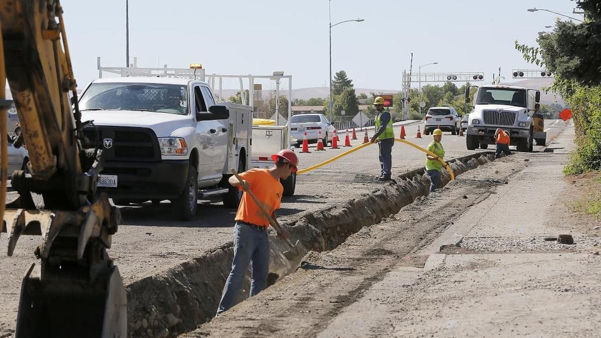 Construction workers install an underground natural gas line recently on North Edison Street as part of a reconstruction project between West Canal Drive and West Clearwater Avenue. The $3 million street widening project by the city of Kennewick also includes a center turn lane, new bike lanes, curbs, gutters and upgraded sidewalks. The project is on schedule to wrap up by the end of August, according to city officials.